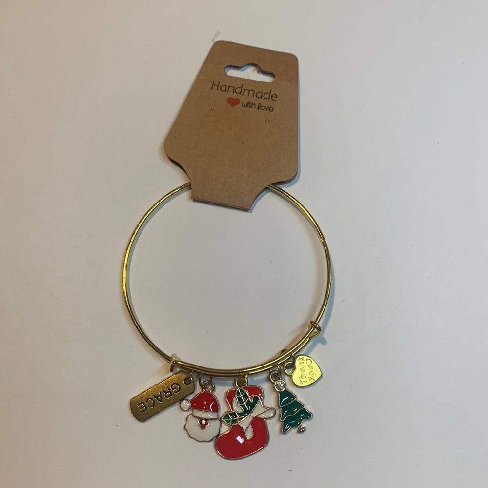 Handmade gold tone stainless steel bracelet with 5 charms.
